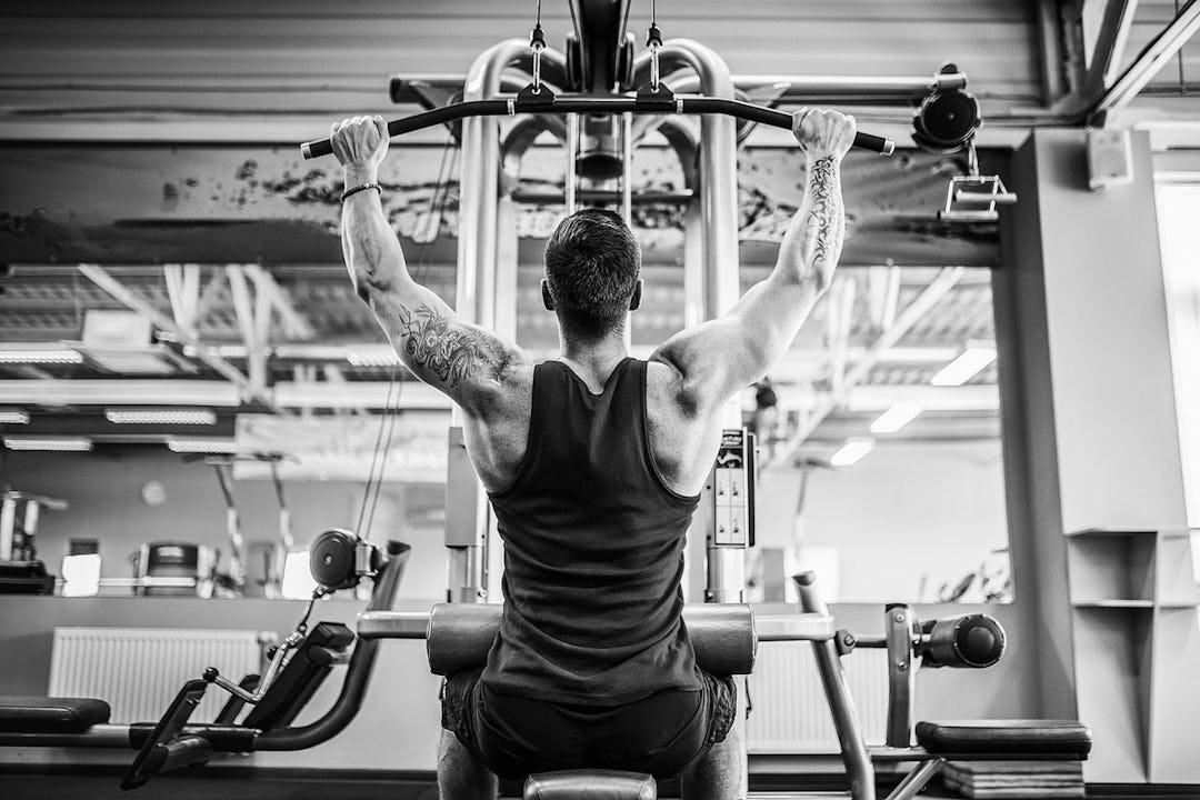 Man demonstrates a lat pulldown.