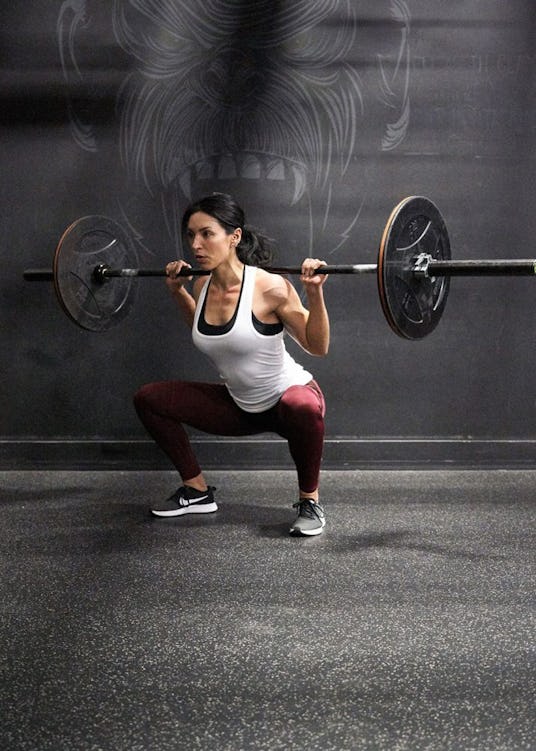Trainer Carmen Morgan demonstrates the back squat