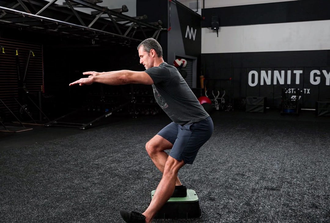 Onnit Editor-in-Chief Sean Hyson demonstrates the touchdown squat