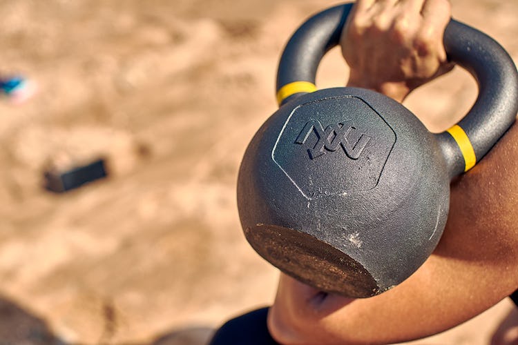 Woman holding an Onnit kettlebell