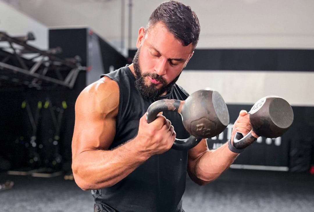Eric Leija performs the Zottman curl kettlebell arm exercise.