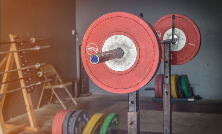Weightlifting rack with bumber plates.