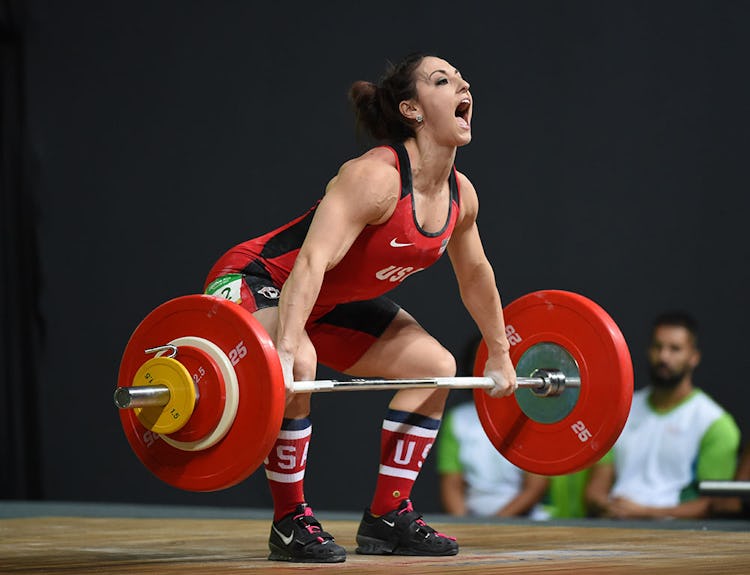 Female weightlifter demonstrates a clean from the hang position.