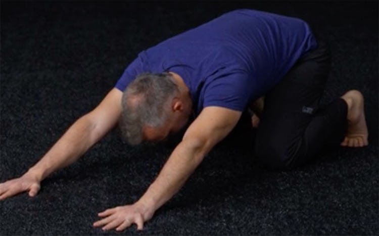 Shane Heins demonstrates the kneeling child's pose to updog exercise.